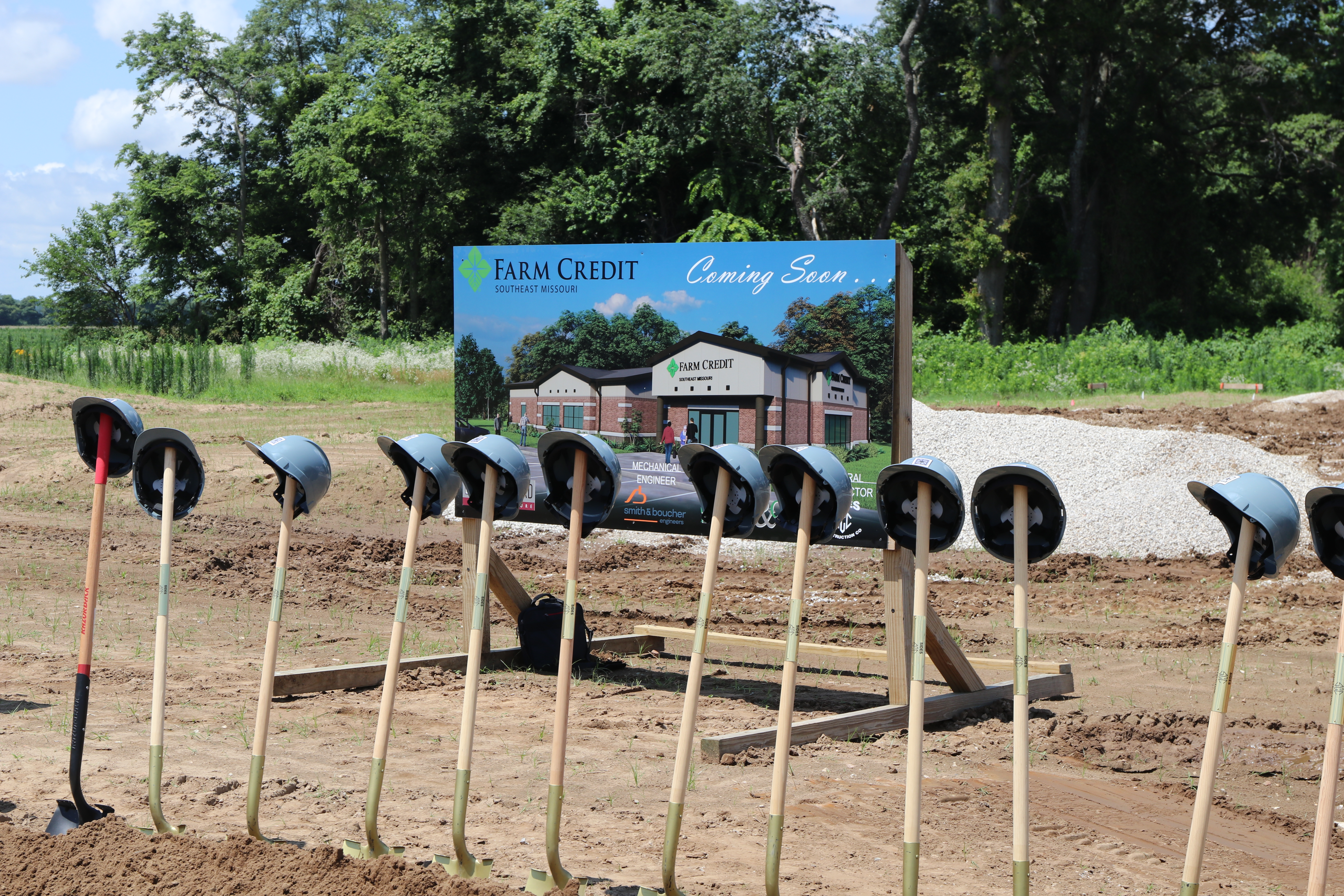 groundbreaking shovels, hard hats, and sign