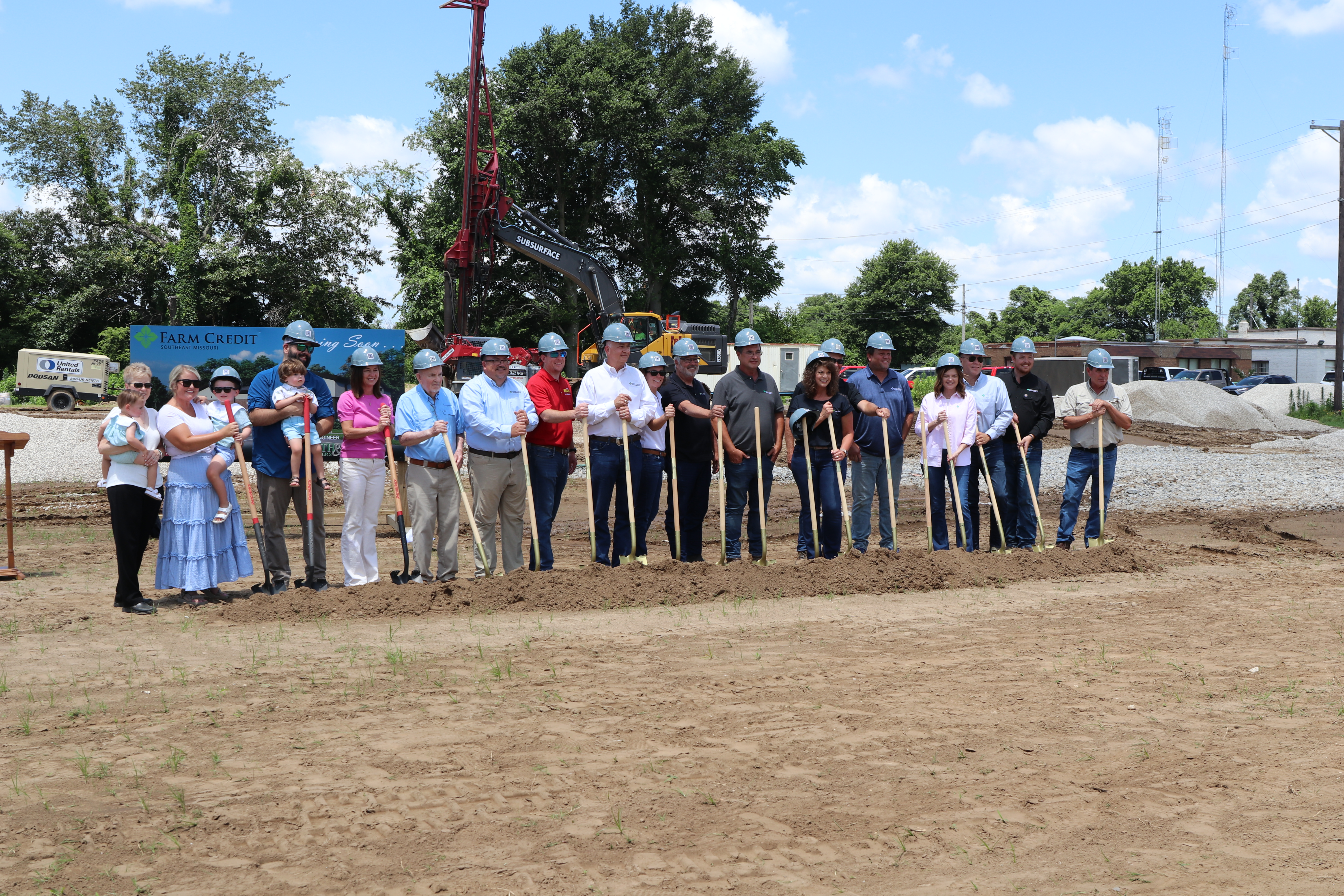 groundbreaking group poses with shovels